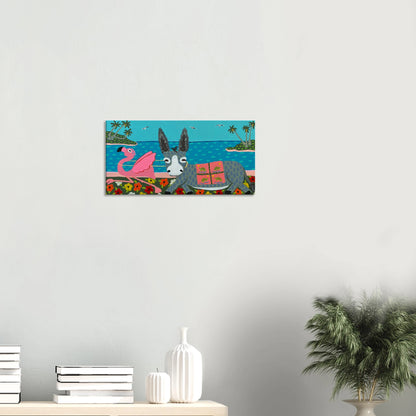 Canvas print of a donkey and flamingo on a beach scene hanging on a wall.